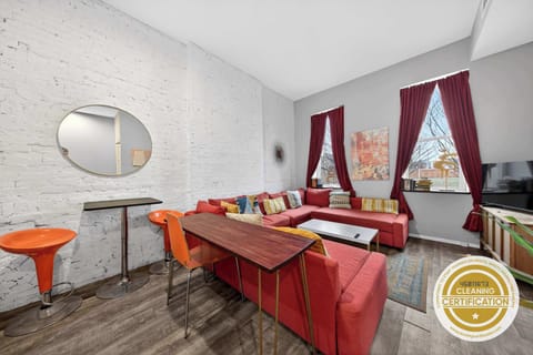 This cozy living room features a plush couch and a vibrant red sectional, perfect for lounging after a day of adventure. Gather around the coffee table for game night or unwind with your favorite book