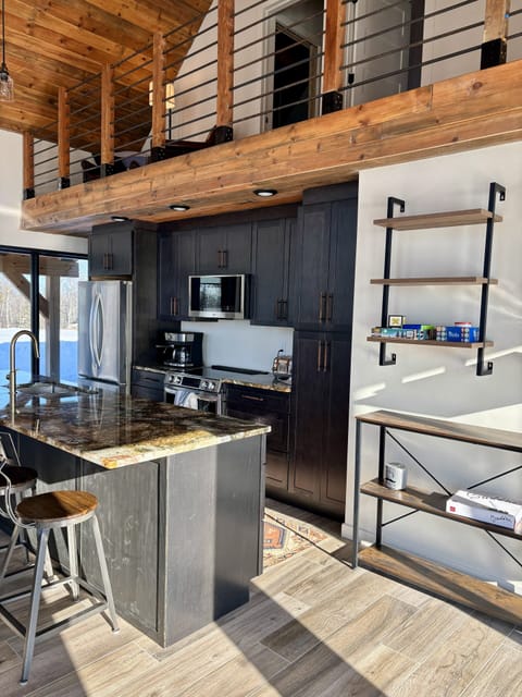 Modern kitchen with 10-foot island seats five.  Induction range heats fast.