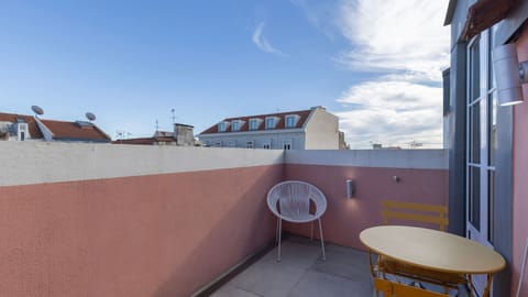 A charming outdoor space with cheerful yellow furniture and rooftop views, perfect for coffee or sunset drinks. #TerraceVibes #OutdoorEscape
