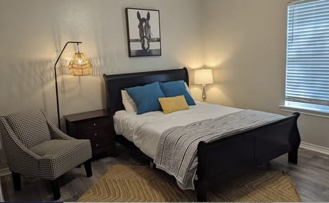 Bedroom 2 has queen bed, desk, and en suite full bathroom