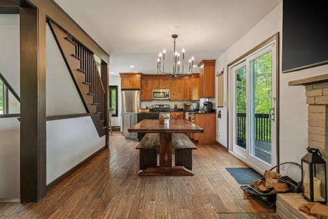 Fully stocked kitchen and dining table with sliding door to deck