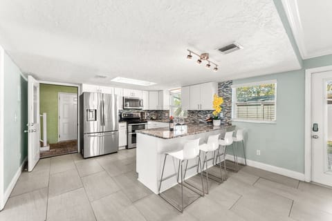 Downstairs Unit 1: Kitchen that Opens to Sauna & Pool Area