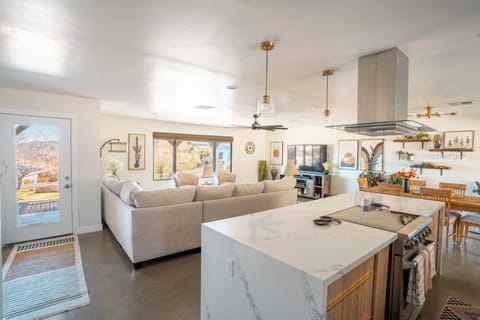 Open concept living with a large comfortable couch. Room for everyone!