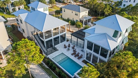 Gather around your private pool, hot tub, and glowing fire bowl after a day at the beach at this peaceful retreat featuring a spacious 4-bedroom main house and charming 2-bedroom guest house—perfect for unforgettable group getaways with family and friends.