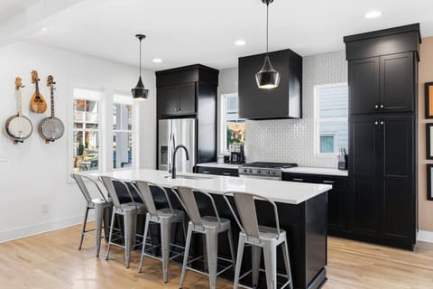 Spacious, fully-equipped kitchen for all your cooking needs. Modern appliances, natural lighting, and a large kitchen island with seating for 5.