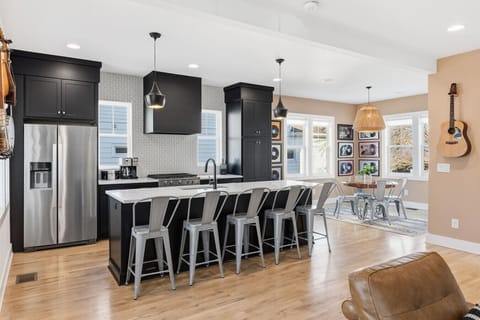 Spacious, fully-equipped kitchen for all your cooking needs. Modern appliances, natural lighting, and a large kitchen island with seating for 5. Dining area with additional seating for 4.