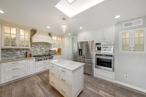 Beautiful kitchen with upgraded appliances, island, plenty of counter space and storage, and seating at the peninsula