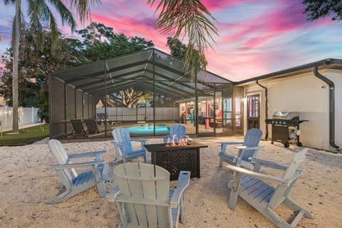 Cozy firepit nights with seating, sunsets & screened pool.