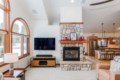 Cozy up by your stone fireplace while snow blankets the trees outside your picture windows.