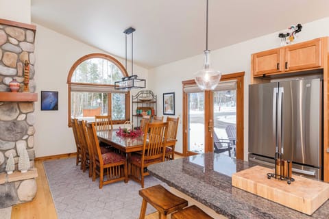 Gather around this inviting dining table where natural light streams through arched windows, creating the perfect setting for memorable meals together.