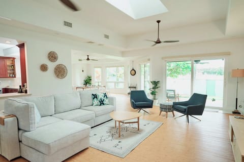 Relax in your bright, modern living space with soaring ceilings, stylish furnishings, and views of the peaceful garden.