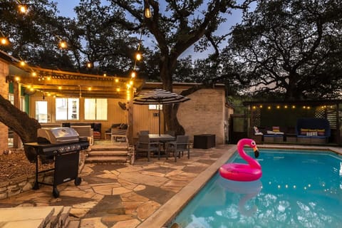 Magical backyard pool at night with string lights — the ultimate private San Antonio getaway.