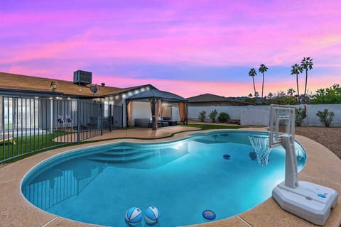 Unwind by the sparkling pool at sunset—complete with a poolside hoop and plenty of patio space for lingering evenings outside.