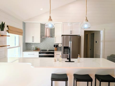 Step into a kitchen where modern minimalism meets lakeside warmth.