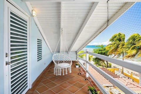 Relax on your private balcony just steps from the beach.