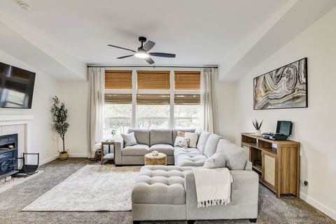 The living room features a large sectional sofa that pulls out into a queen bed.