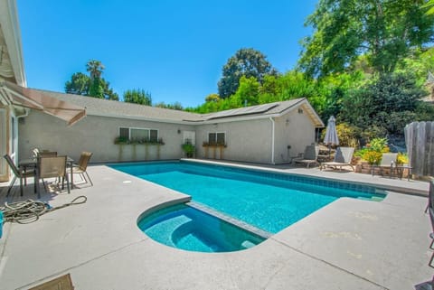 Relax in the spa, take a dip in the heatable pool, or lounge under patio umbrellas in this private backyard retreat.