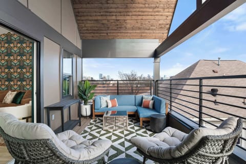 Covered balcony with comfortable lounge seating—perfect for morning coffee or evening conversations.