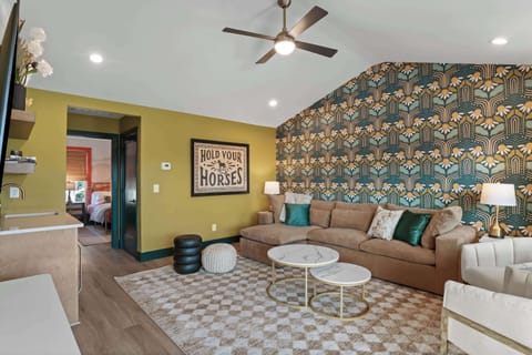 Inviting bonus living area with plush seating, designer wallpaper, and a warm, welcoming atmosphere.