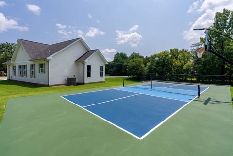 Pickleball court, freshly painted and a full basketball hoop setup for endless outdoor recreation 