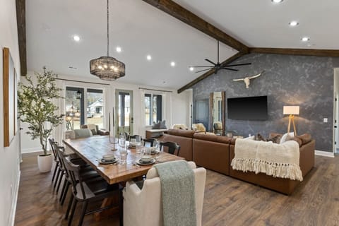 Our spacious dining area (seats 10 + additional island seating) with oversized 72in TV; large enough for the entire group to comfortably spread out.