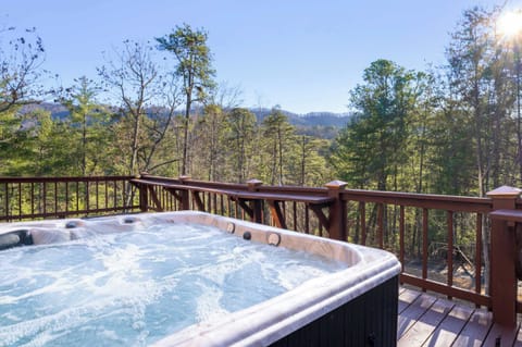 Relax in the private porch hot tub while soaking in breathtaking mountain and forest views.