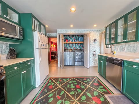 The washer and dryer are located in the kitchen.