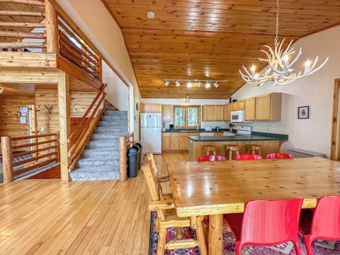 The dining room with the kitchen behind it and the stairs leading to the loft bedroom.