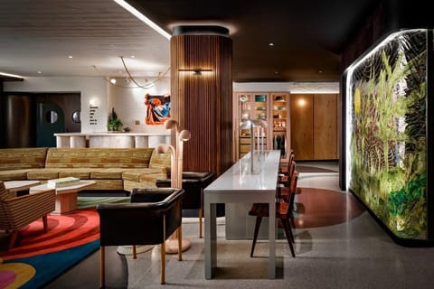 The Drake Hotel's lobby showcases an inviting boutique hotel style with vibrant art and modern furnishings that embody the energy of Queen West.