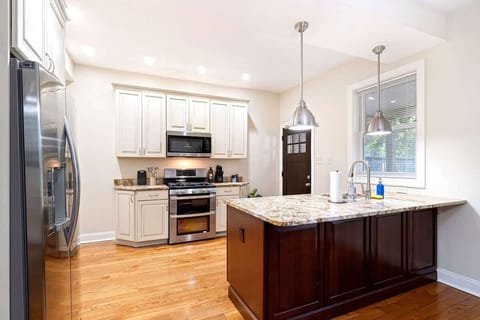 Spacious gourmet kitchen featuring granite countertops, stainless steel appliances, and a large center island perfect for cooking or gathering.