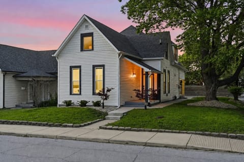 Charming cottage-style home with warm porch glow and inviting curb appeal