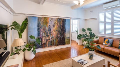 Light-filled living room with curated art and greenery