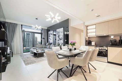 Dine with a view: the living room just steps away and the city skyline stretching out through massive windows