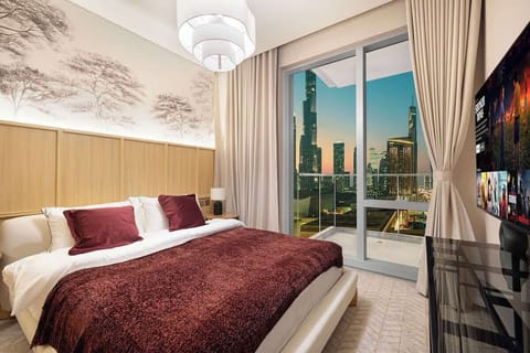 Chic bedroom with a queen bed, TV, and stunning city view