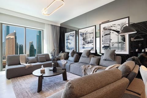 Relax in a cozy living room with a plush sofa, TV, and stunning Downtown Dubai views