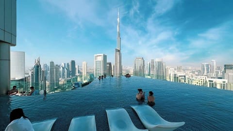 Modern pool with clean lines, comfortable sunbeds, and panoramic city views