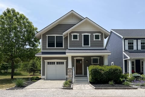 Welcome to Daydreamer Cottage a bright and beautifully designed retreat, This two-story home features a covered front porch and an attached garage,