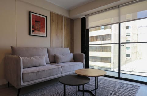 Cozy living area featuring a comfortable sofa, modern décor, and a welcoming atmosphere ideal for relaxing.