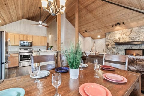 Kitchen area with table and breakfast bar area overlooking the large deck and pond