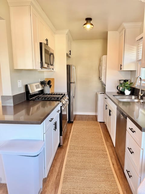 Kitchen with washer/dryer, gas stove, cooking essentials & 2 person dining table