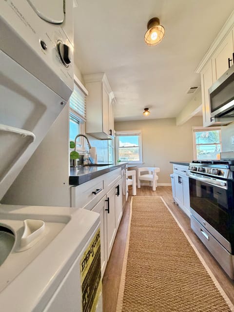 Kitchen with washer/dryer, gas stove, cooking essentials & 2 person dining table