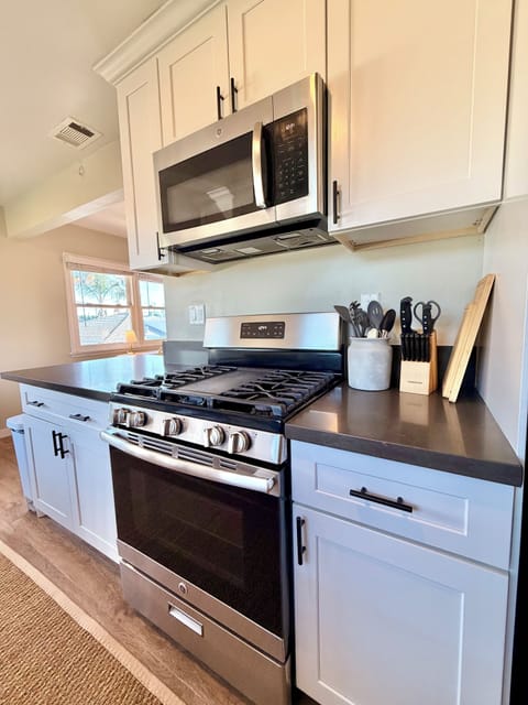 Kitchen with washer/dryer, gas stove, cooking essentials & 2 person dining table