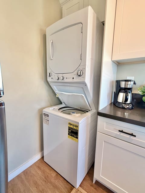 Kitchen with washer/dryer, gas stove, cooking essentials & 2 person dining table