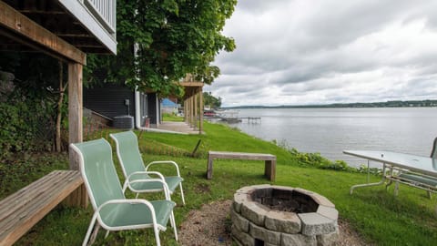 Grassy lakeside yard with chairs for front-row water views.