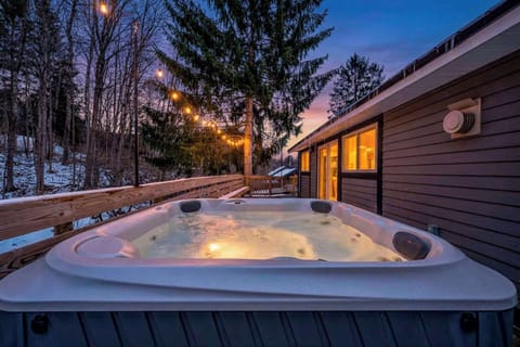 Enjoy a relaxing soak in this inviting outdoor hot tub, surrounded by peaceful wooded views. A perfect spot to unwind any time of the day.