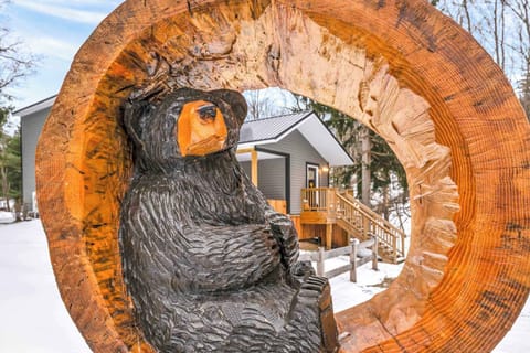 A charming carved bear sculpture welcomes you to the property, adding a unique and playful touch to the outdoor scenery.