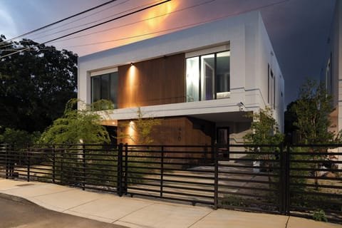 Modern luxury villa exterior with elegant night lighting.