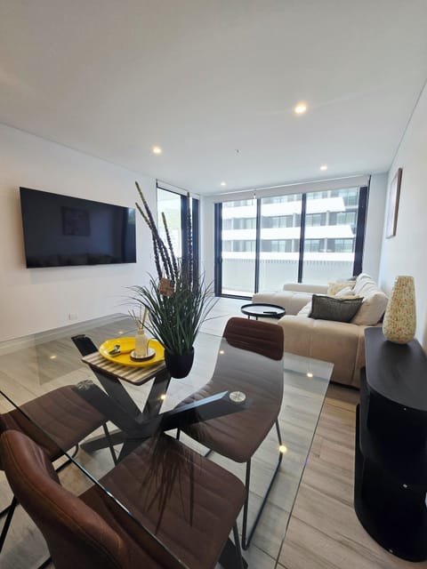 Living room with wall mounted 75inch qled 4k smart TV. Brand new furniture. 