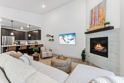 Sink into plush seating by your crackling fireplace, where modern comfort meets cozy warmth in this beautifully appointed living space.