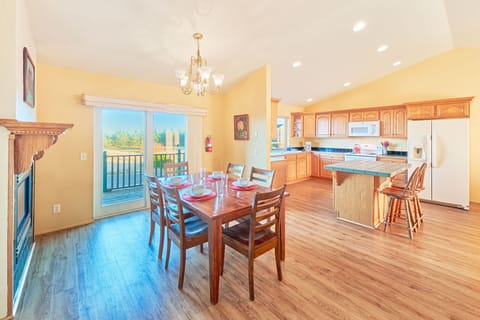 Open-concept kitchen offering two dining tables with seating for six at each